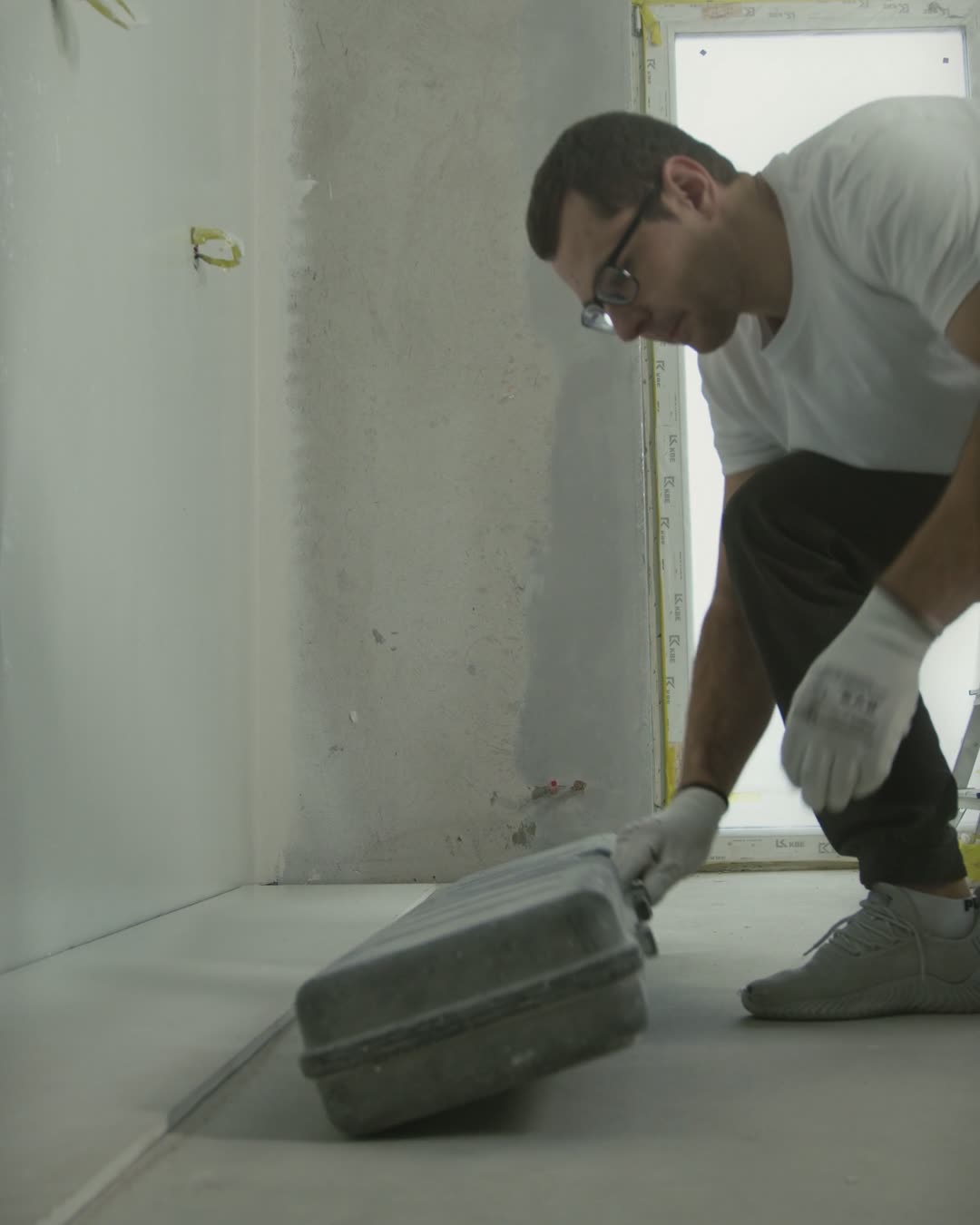 Example before photo: an unfinished room with bare concrete walls